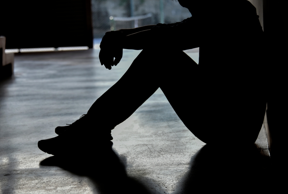 person sitting in a hallway